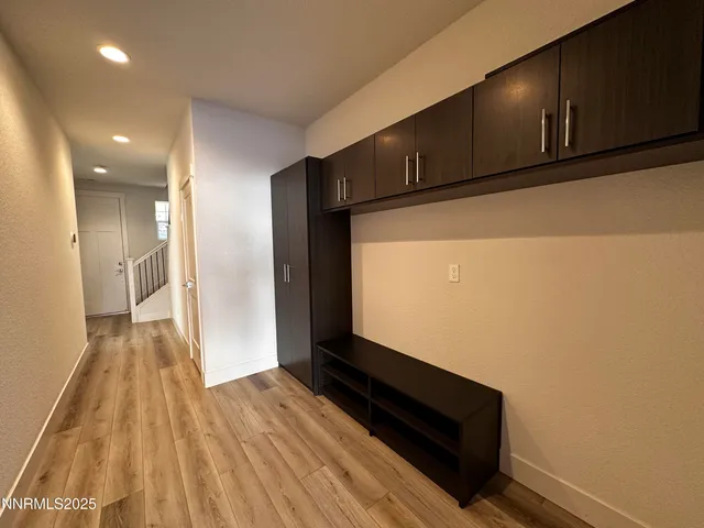 a view of hallway with wooden floor and stairs