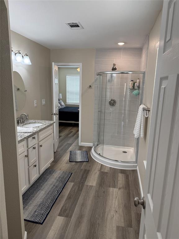217 Comanche Trail Nocona, TX 76255 - Photo 11 of 13 a spacious bathroom with a double vanity sink a toilet a mirror and shower