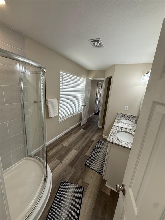 217 Comanche Trail Nocona, TX 76255 - Photo 12 of 13 a spacious bathroom with a granite countertop sink a toilet a mirror and shower