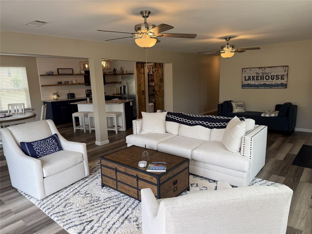 217 Comanche Trail Nocona, TX 76255 - Photo 2 of 13 a living room with furniture and a chandelier