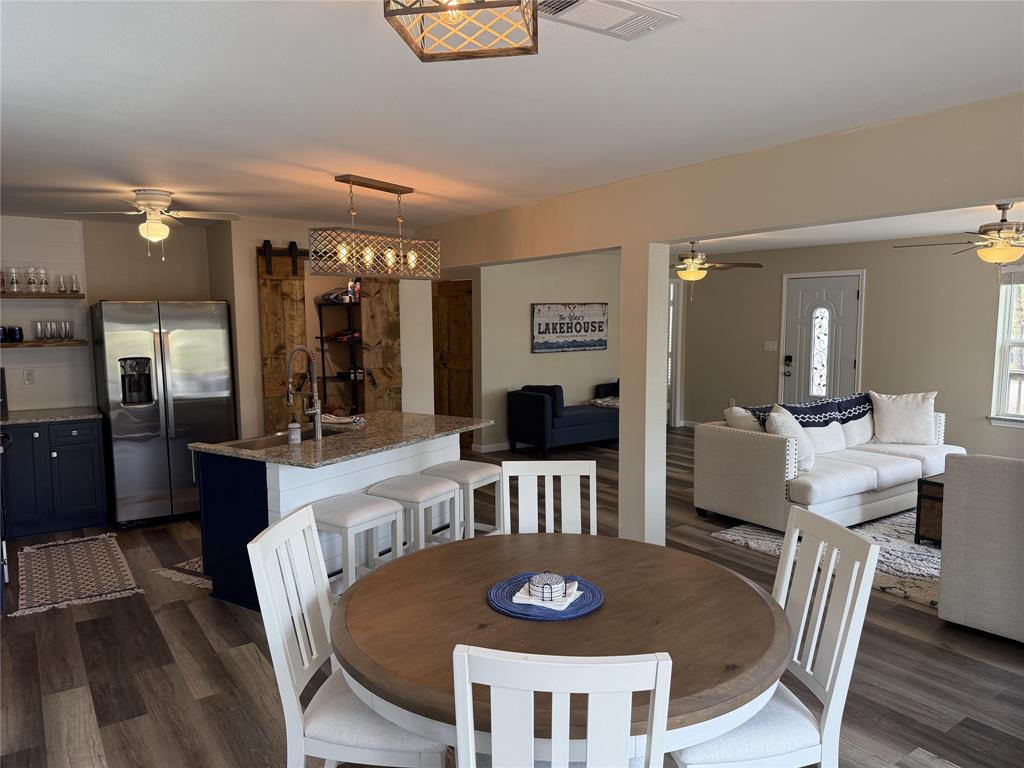 217 Comanche Trail Nocona, TX 76255 - Photo 5 of 13 a view of a dining room with furniture and wooden floor