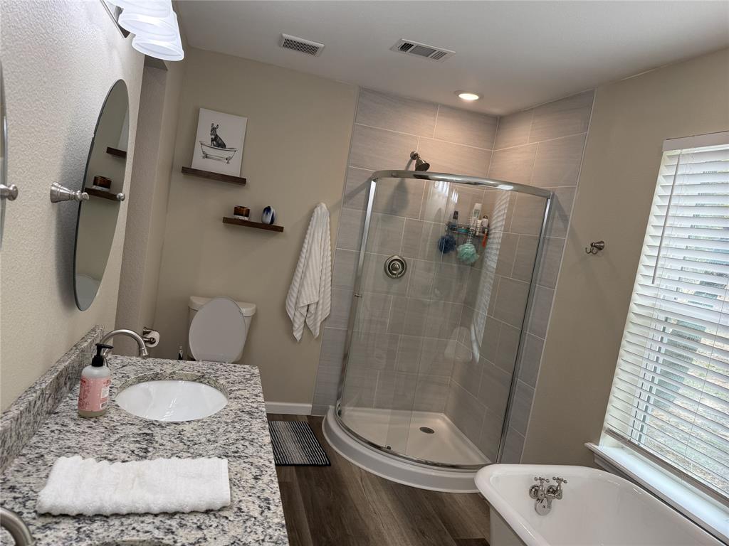217 Comanche Trail Nocona, TX 76255 - Photo 7 of 13 a bathroom with a granite countertop sink toilet and shower