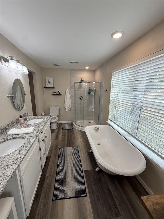 217 Comanche Trail Nocona, TX 76255 - Photo 8 of 13 a spacious bathroom with a granite countertop sink a mirror and a bathtub