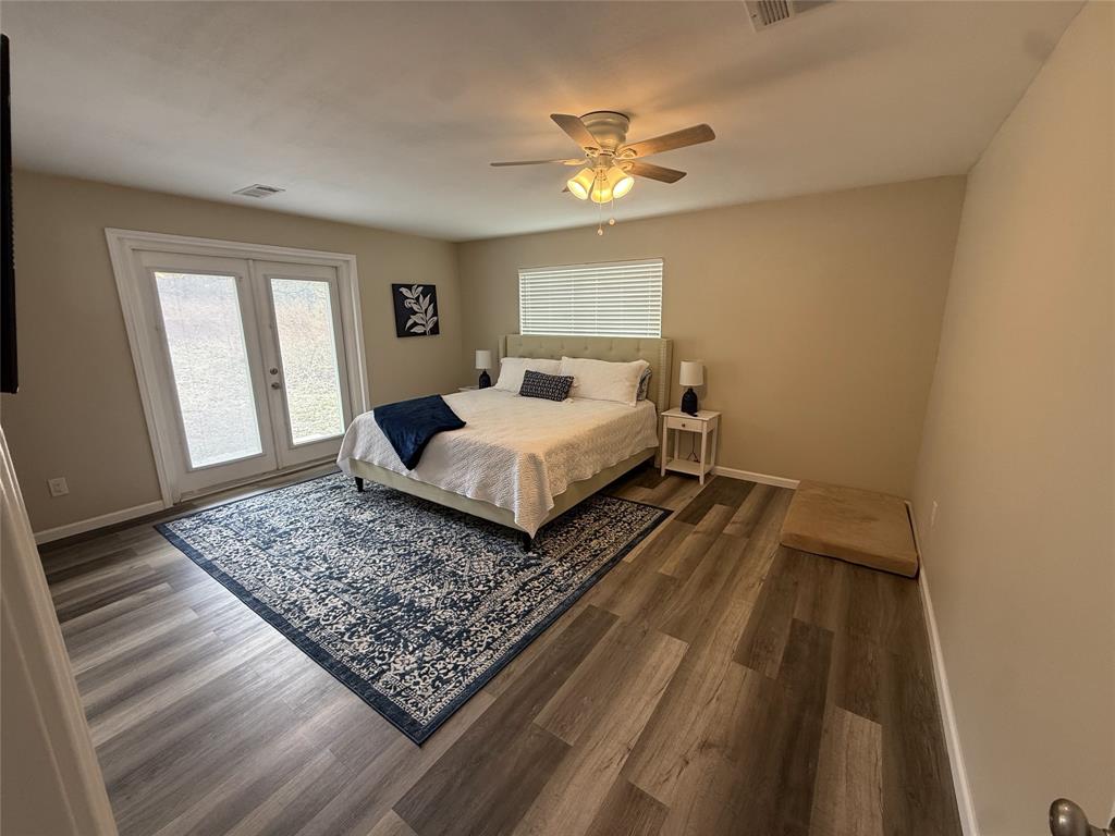 217 Comanche Trail Nocona, TX 76255 - Photo 9 of 13 a bedroom with a bed rug and wooden floor