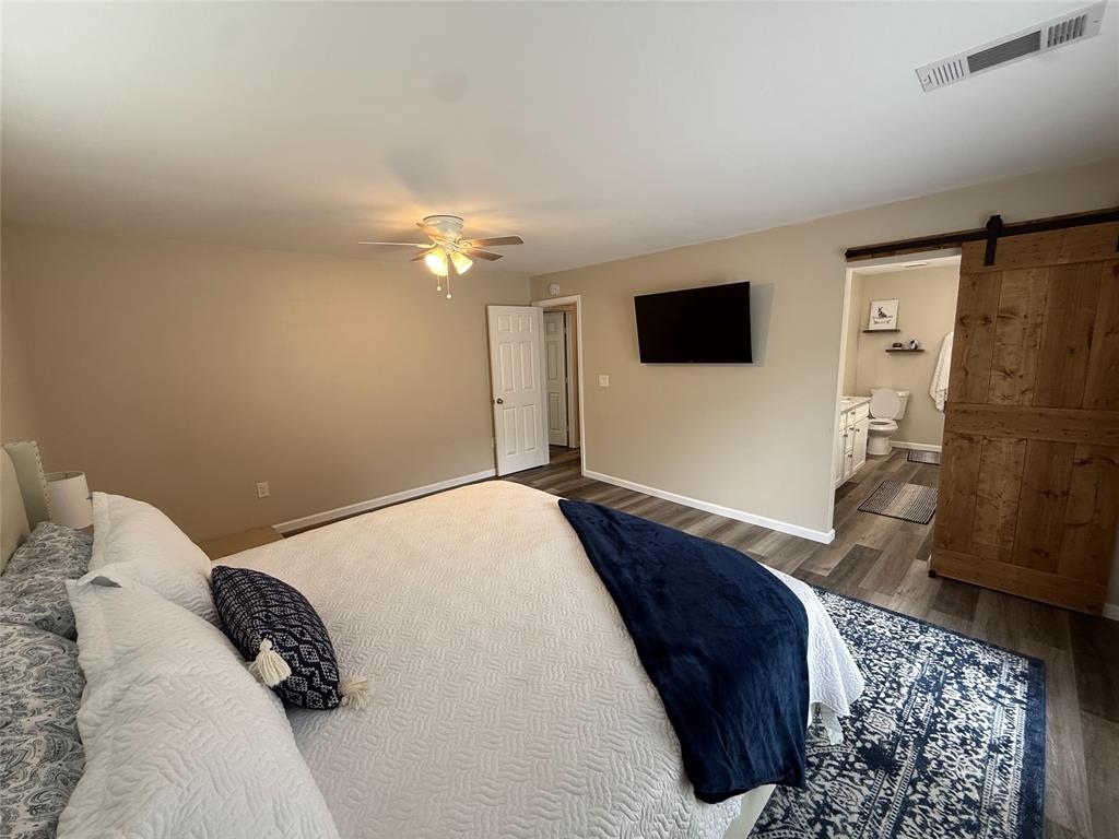 217 Comanche Trail Nocona, TX 76255 - Photo 10 of 13 a bedroom with a bed and a flat screen tv