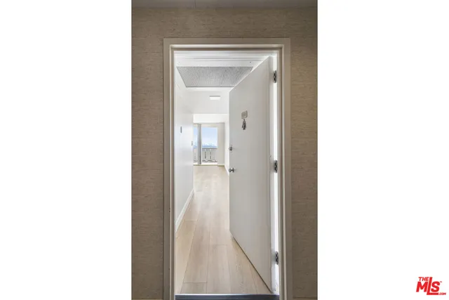 a view of a bathroom with a shower and a mirror