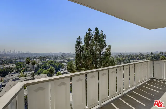 a view of a balcony with wooden fence and floor
