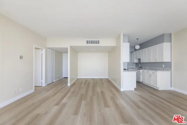 a view of kitchen with granite countertop cabinets and sink