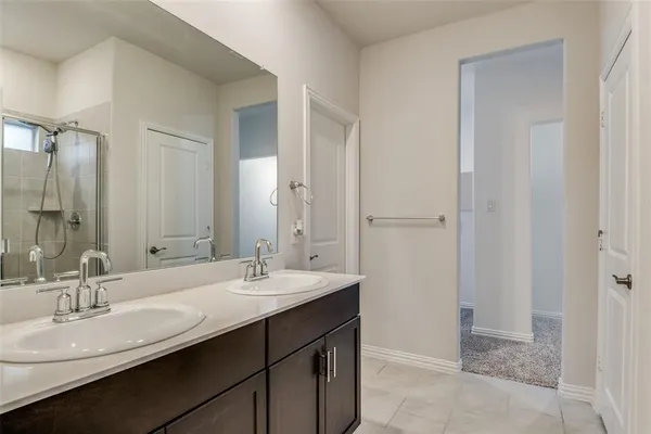 a bathroom with a double vanity sink a and a mirror