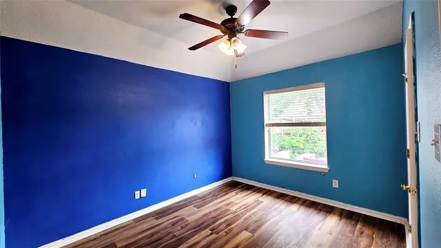 a view of a room with a ceiling fan and a window