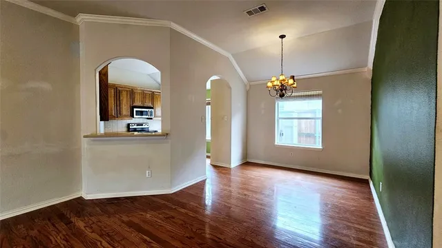 a view of a room with window and wooden floor