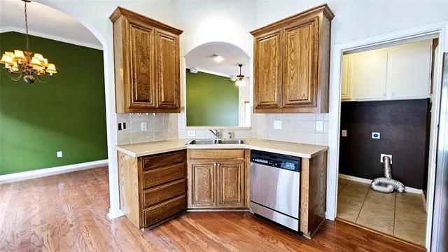 a kitchen with a sink cabinets and wooden floor