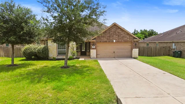 a front view of house with yard and green space