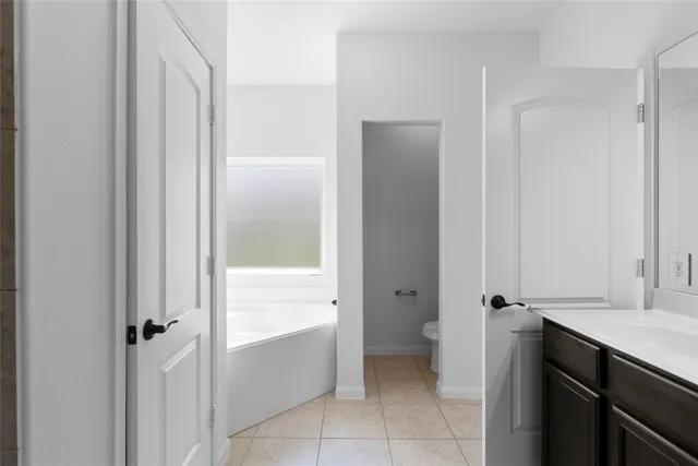 a bathroom with a tub shower and sink