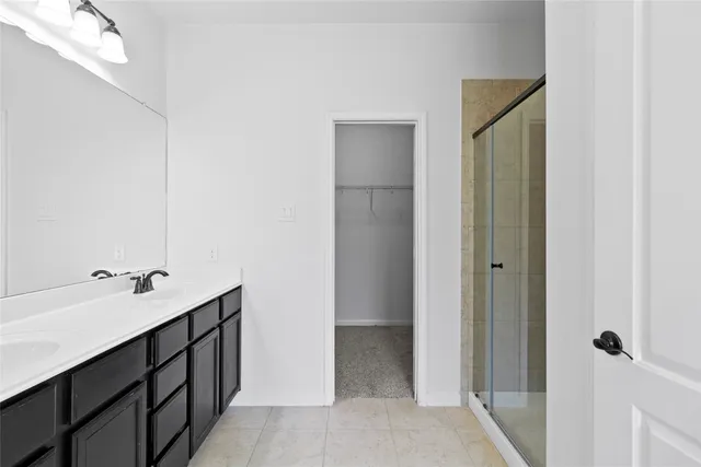 a bathroom with a double vanity sink and mirror