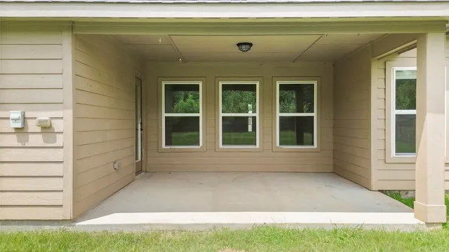 a view of an house with backyard space and balcony