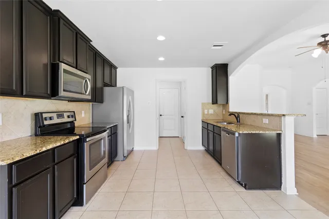 a large kitchen with stainless steel appliances