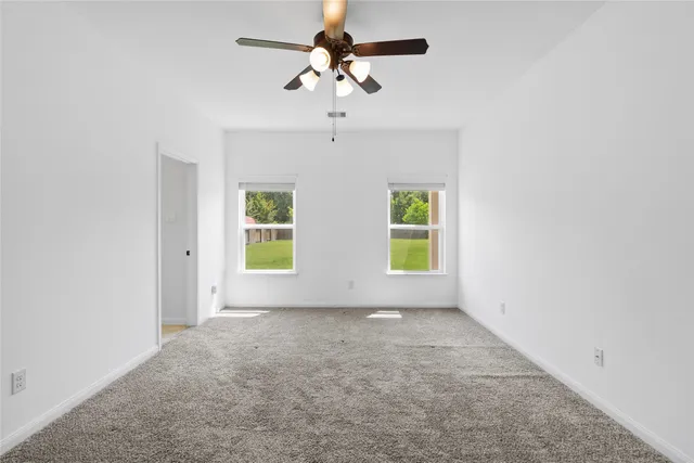 a view of room with window and ceiling fan