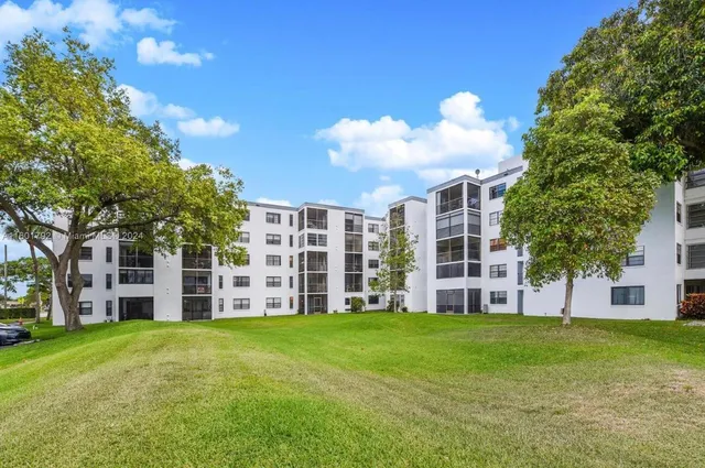 a large house with a big yard and large trees