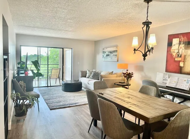 a living room with furniture two window and wooden floor