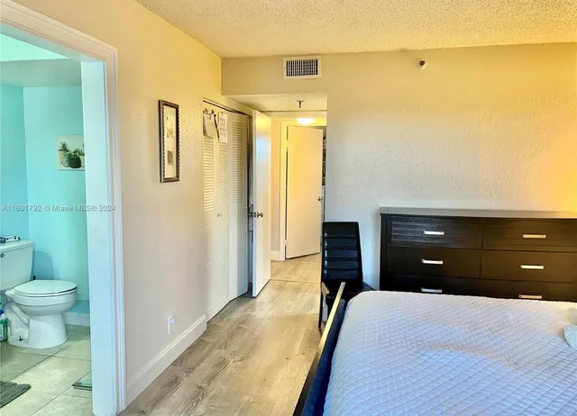 a bedroom with a bed and a bathroom