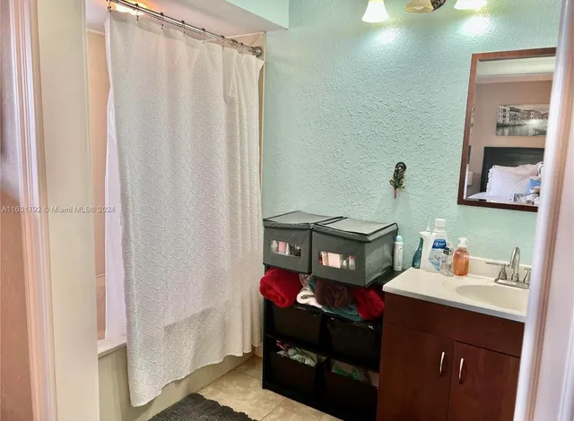 a bathroom with a sink vanity and a mirror