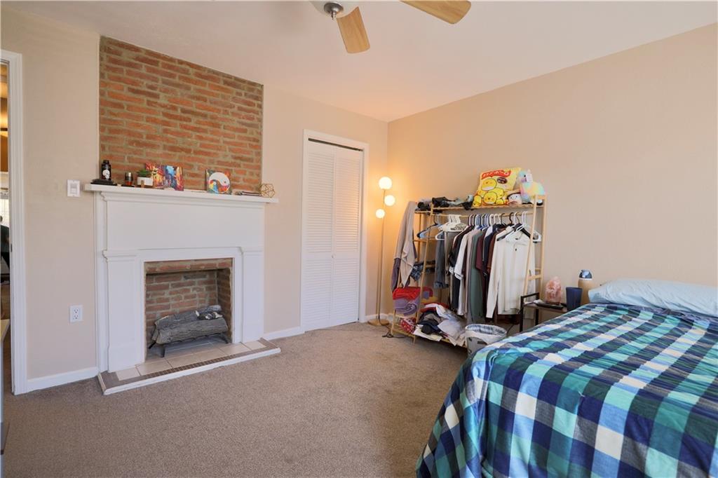 1923 Wharton Street Pittsburgh, PA 15203 - Photo 23 of 34 a bedroom with bed and a fireplace