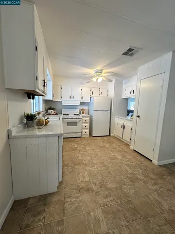 a view of a workspace with furniture and window