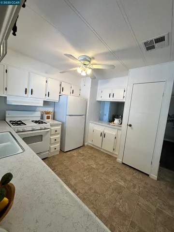 a view of a livingroom with furniture and book shelf