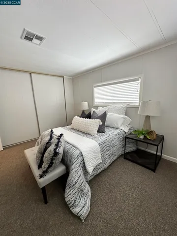 a spacious bathroom with a double vanity sink toilet and a mirror