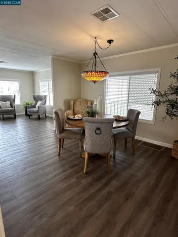 a kitchen with stainless steel appliances granite countertop a stove top oven a sink a refrigerator and white cabinets