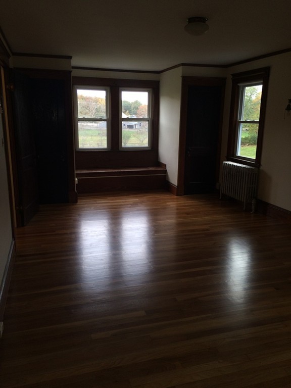 25 Argilla Road Ipswich, MA 01938 - Photo 16 of 20 an empty room with wooden floor and windows