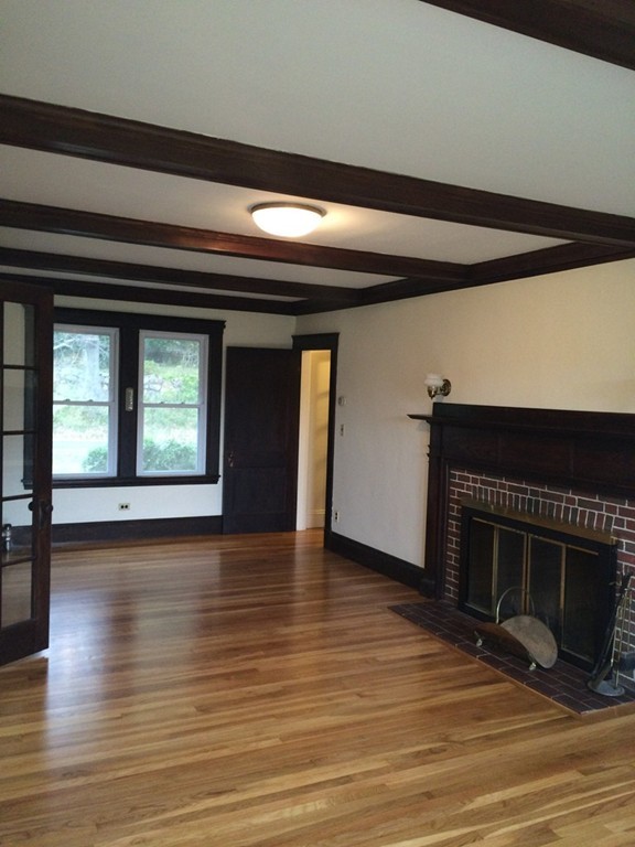 25 Argilla Road Ipswich, MA 01938 - Photo 8 of 20 a view of empty room with wooden floor and fireplace