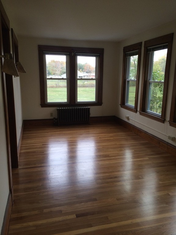 25 Argilla Road Ipswich, MA 01938 - Photo 10 of 20 an empty room with wooden floor and windows