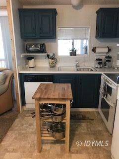 18 Pine Cove Road Idyllwild, CA 92549 - Photo 2 of 14 a kitchen with a sink a stove and cabinets