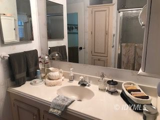 18 Pine Cove Road Idyllwild, CA 92549 - Photo 3 of 14 a bathroom with a granite countertop sink and a mirror