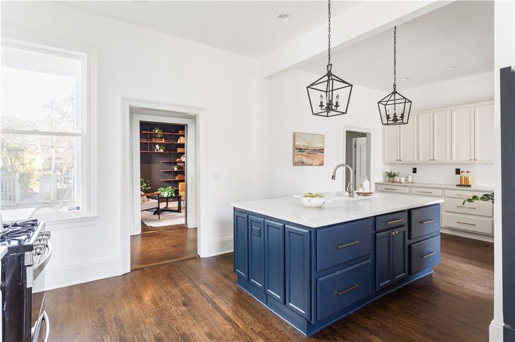 679 Lawton Street Southwest Atlanta, GA 30310 - Photo 14 of 45 a bathroom with a sink a vanity and a mirror