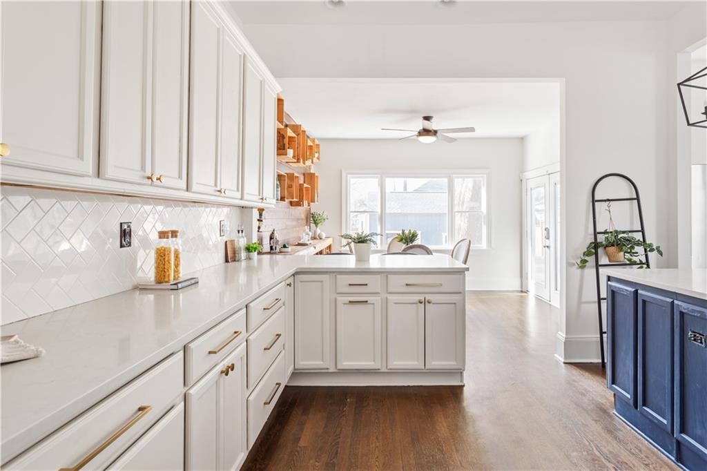 679 Lawton Street Southwest Atlanta, GA 30310 - Photo 16 of 45 a kitchen with granite countertop white cabinets and white appliances