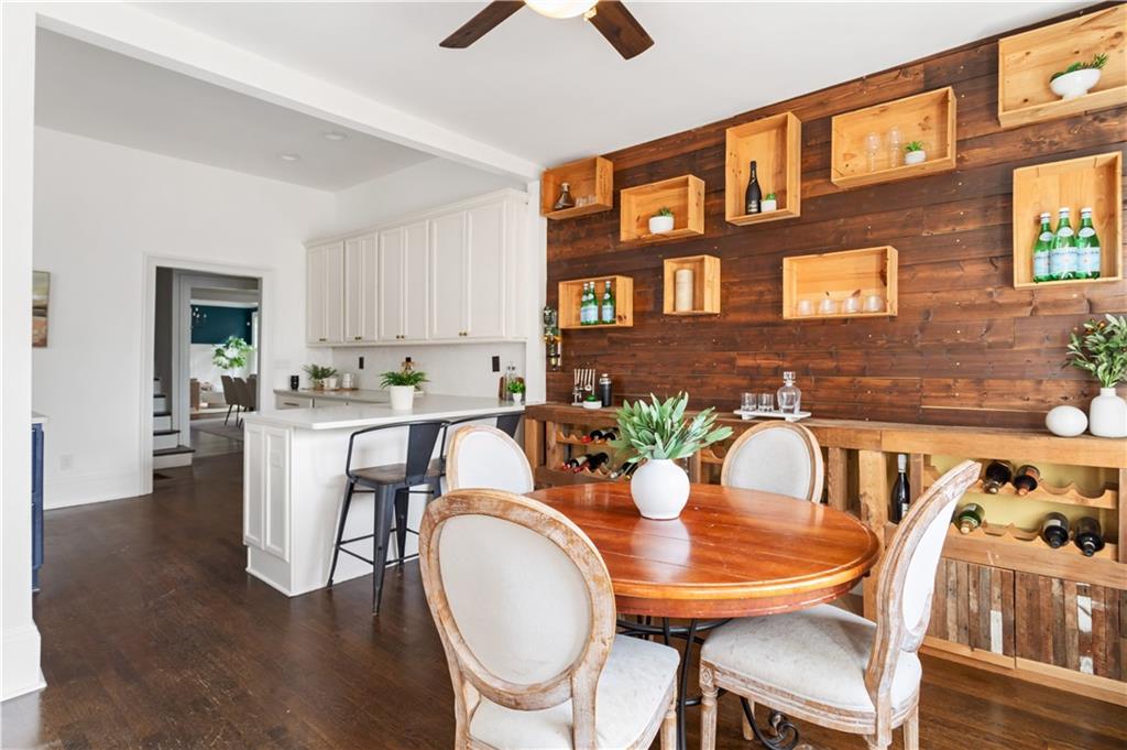 679 Lawton Street Southwest Atlanta, GA 30310 - Photo 17 of 45 a dining room with furniture a rug and wooden floor