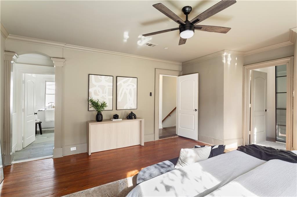 679 Lawton Street Southwest Atlanta, GA 30310 - Photo 23 of 45 a bedroom with a bed and a chandelier