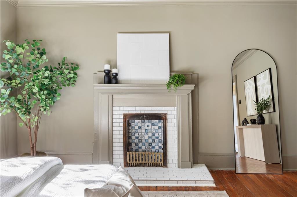 679 Lawton Street Southwest Atlanta, GA 30310 - Photo 24 of 45 a bedroom with a bed and a potted plant