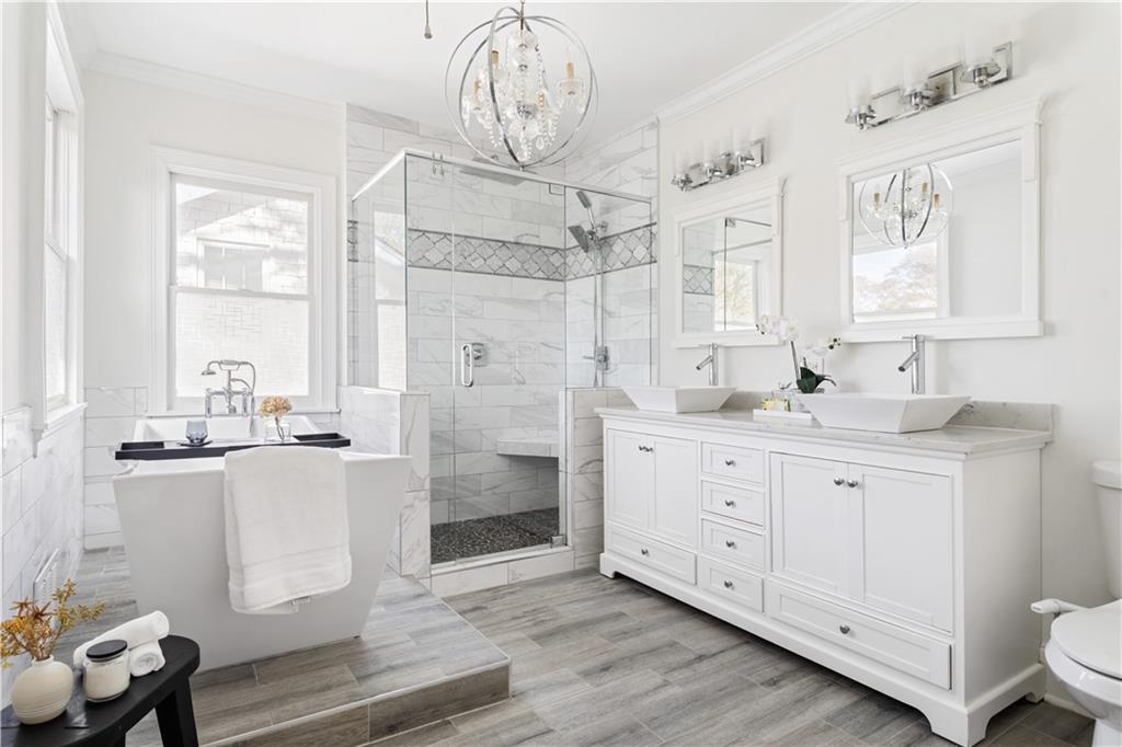 679 Lawton Street Southwest Atlanta, GA 30310 - Photo 25 of 45 a bathroom with a granite countertop sink mirror and a shower