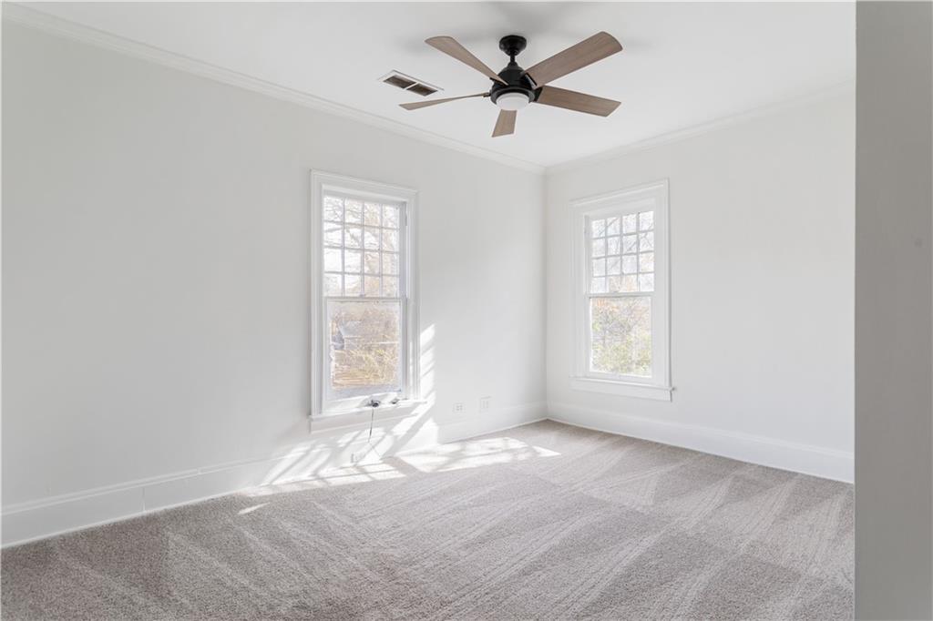 679 Lawton Street Southwest Atlanta, GA 30310 - Photo 30 of 45 a view of a big room with windows and chandelier fan