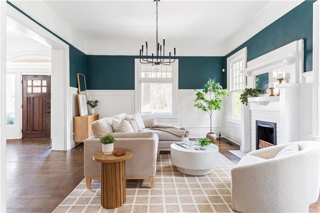 679 Lawton Street Southwest Atlanta, GA 30310 - Photo 4 of 45 a living room with furniture a fireplace and a chandelier