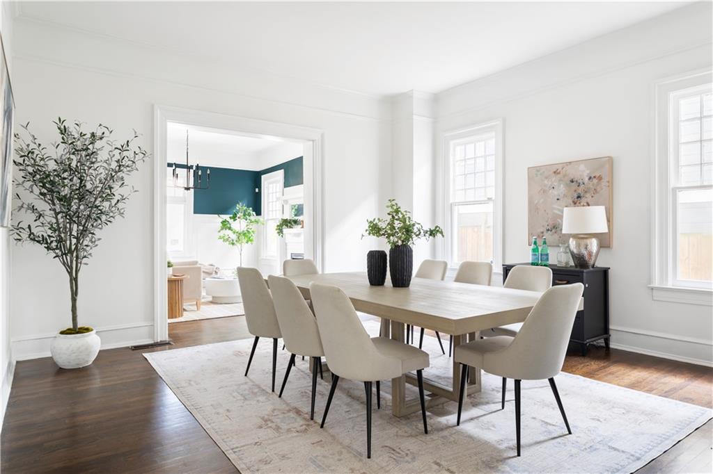 679 Lawton Street Southwest Atlanta, GA 30310 - Photo 8 of 45 a view of a dining room with furniture and wooden floor