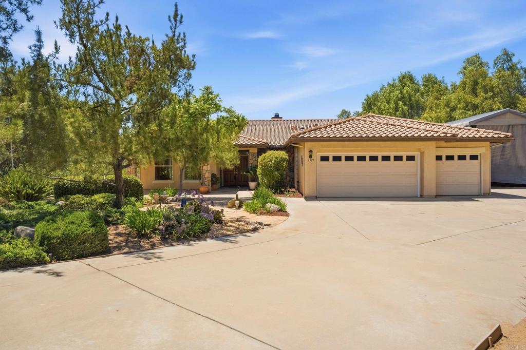 2527 Southern Oak Road Ramona, CA 92065 - Photo 5 of 56 a front view of a building with garden and trees