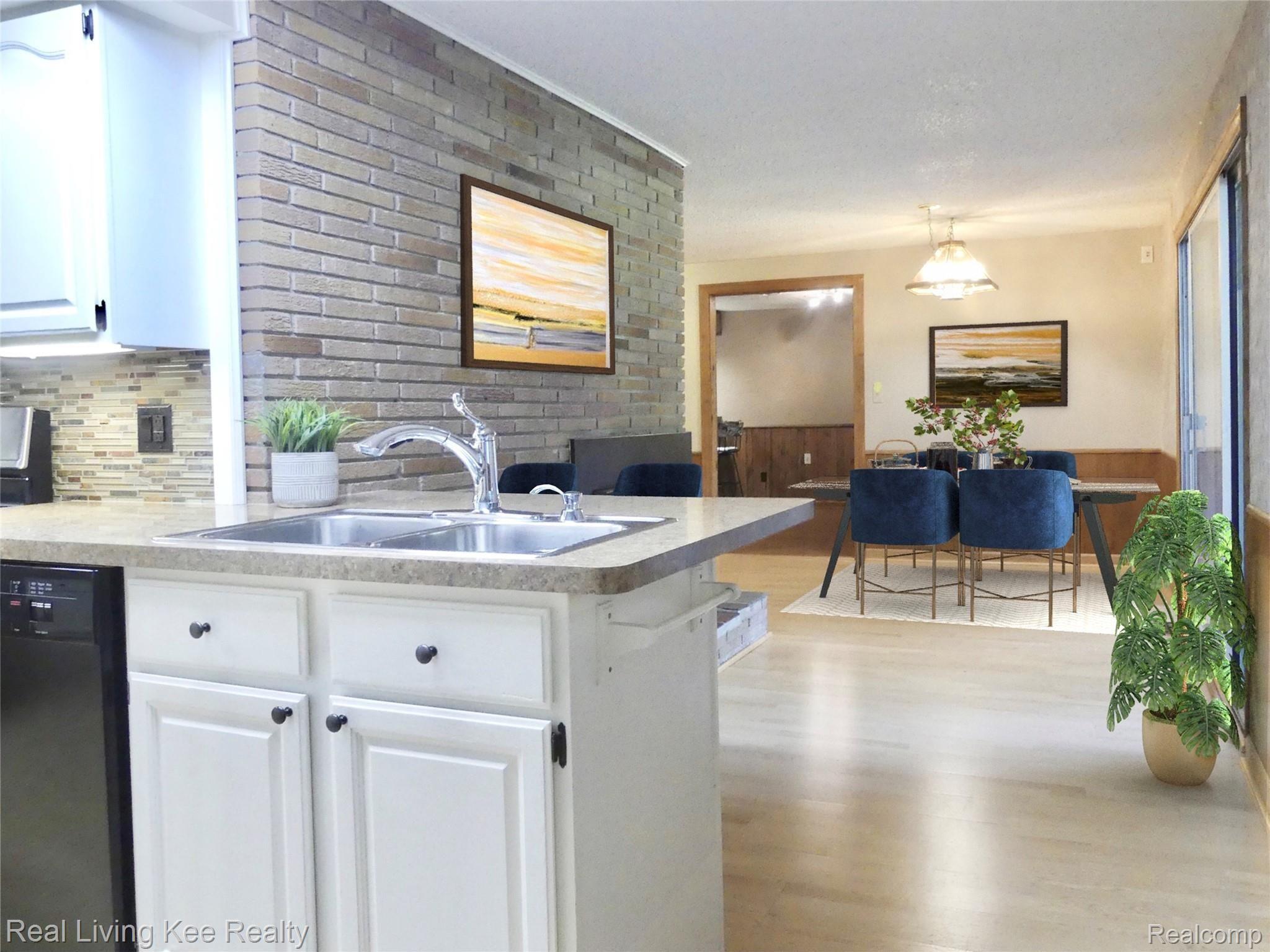 49741 Shelby Road Utica, MI 48317 - Photo 15 of 61 Kitchen into dining rom - virtually staged