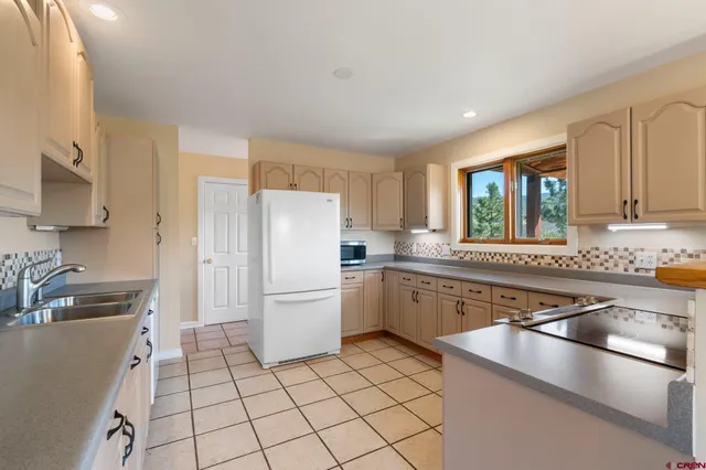 a kitchen with white cabinets and a sink