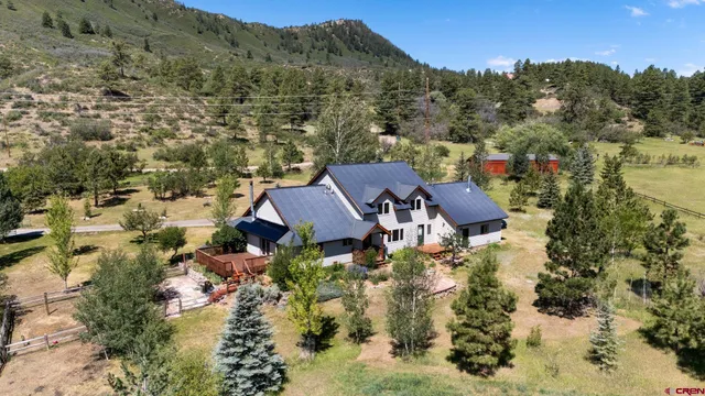 a front view of a house with a yard and trees