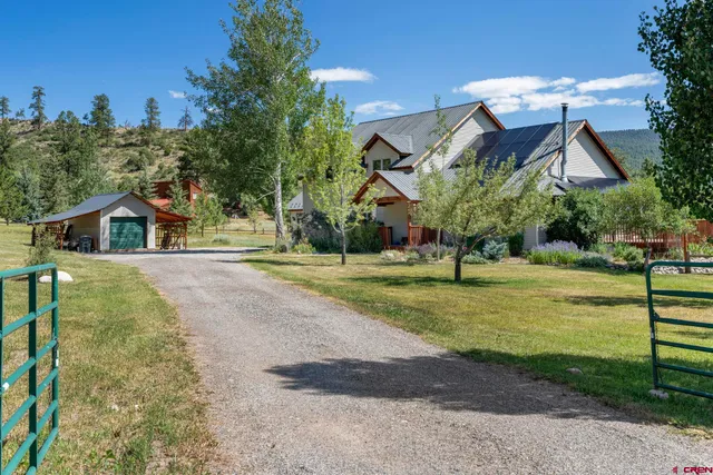 an empty room with wooden floor and large windows